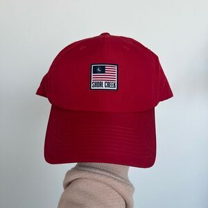 Shoal Creek Performance Golf Hat. Red with American flag patch and eagle logo.